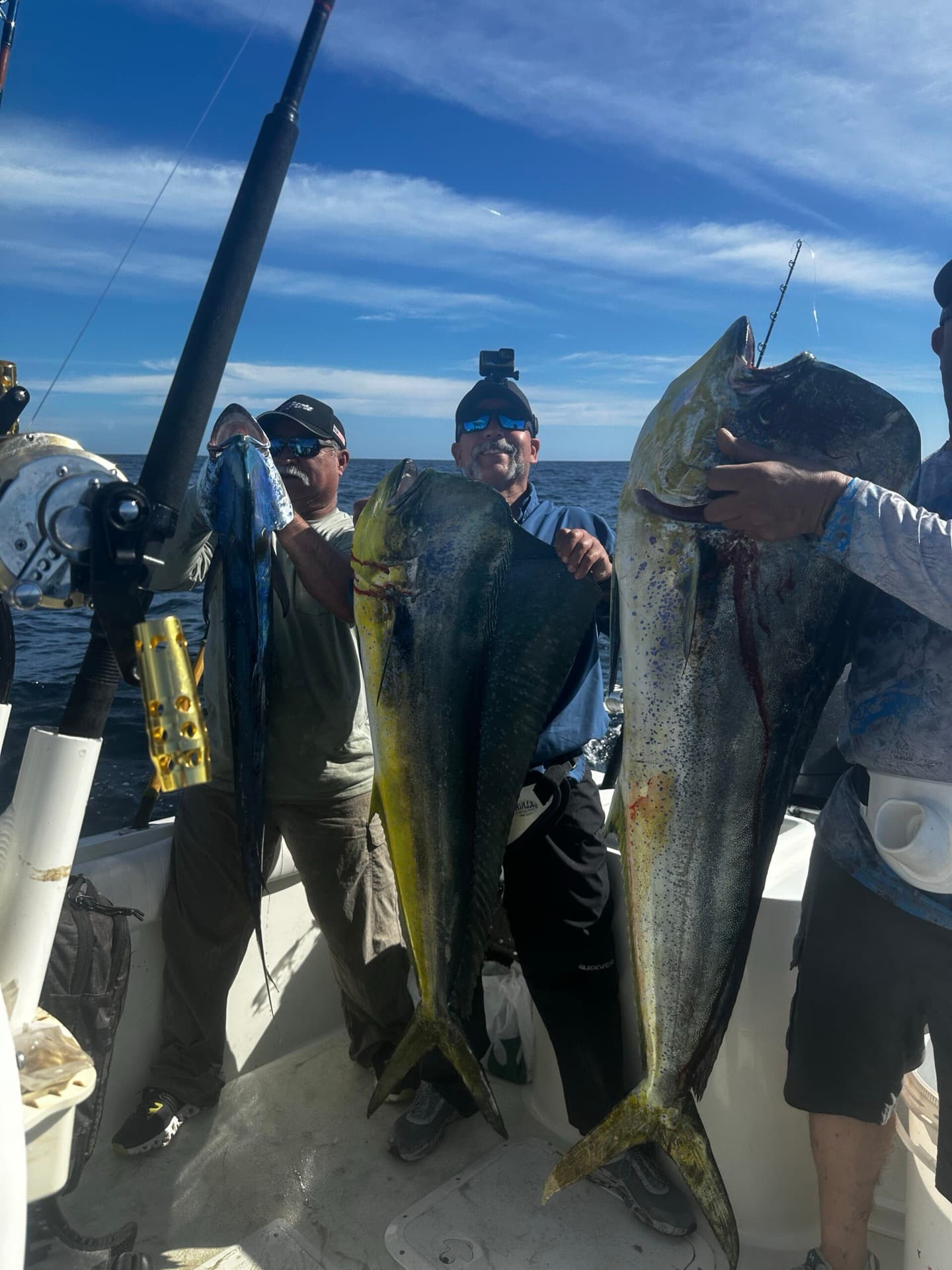 Happy anglers showing off their mahi-mahi catch