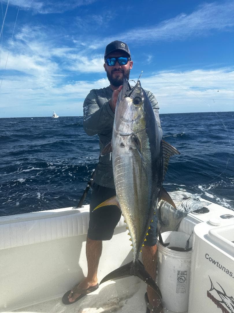 Angler with a yellowfin tuna aboard the Kailani